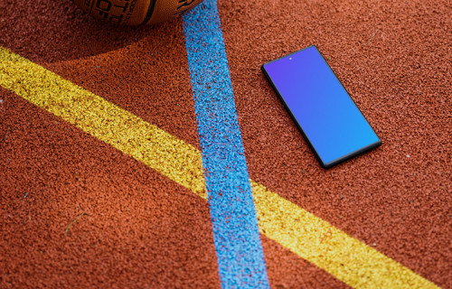 Basketball player standing next to a Google Pixel 6 mockup