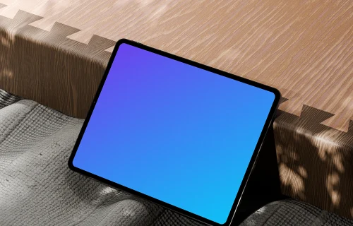 Free iPad Pro mockup on textured fabric and wooden surface