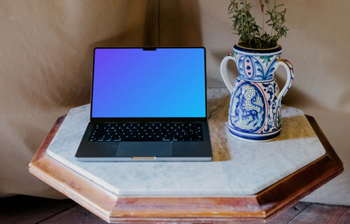 MacBook Pro mockup next to a potted plant