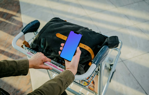 Man hand holding an iPhone 13 mockup