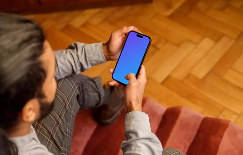 Man typing on a iPhone 14 Pro mockup in the office