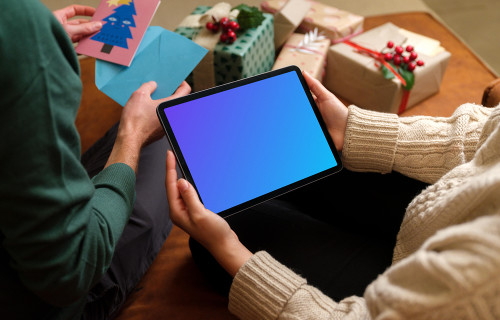 Mockup of a woman holding tablet with a Christmas styling