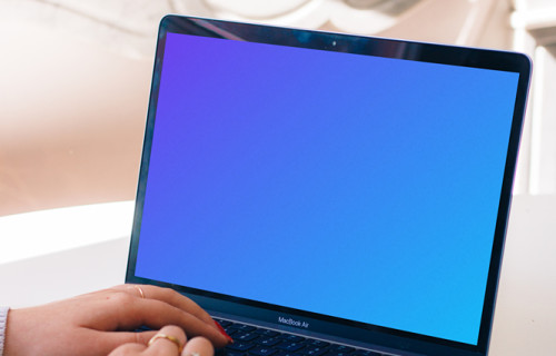 Person typing on a MacBook Air mockup