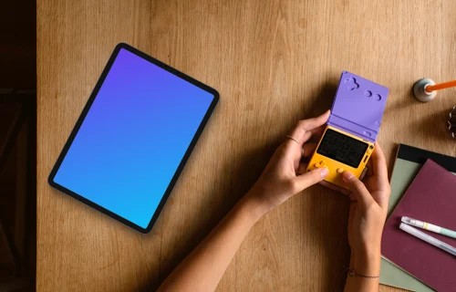 Tablet mockup on a wooden desk with gaming device