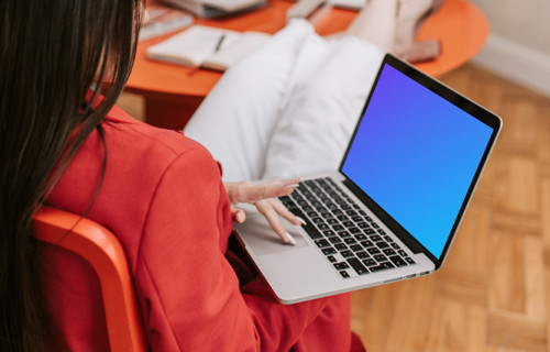 Woman holding a MacBook Pro mockup