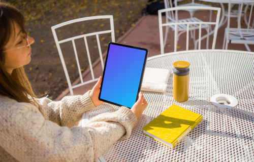 Woman holding an iPad mockup