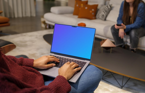 Woman in red sweater typing on a Mac Book Pro 14 mockup