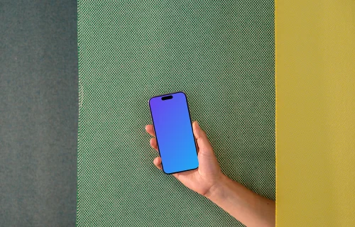 iPhone 15 Pro mockup in hand against dual-tone background