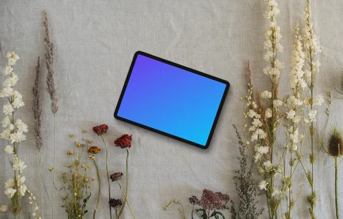 Landscape tablet mockup next to flowers