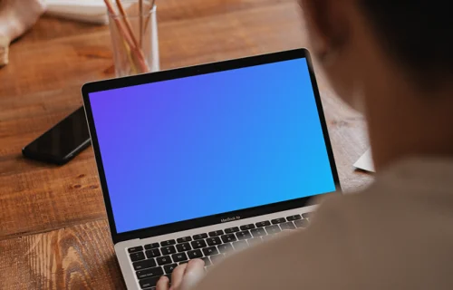 MacBook Pro mockup in a meeting room