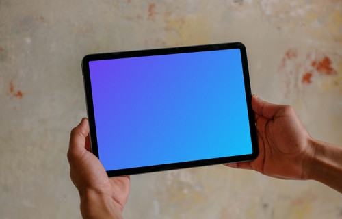 Male hands holding iPad mockup
