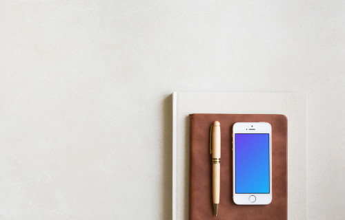 iPhone SE mockup placed on leather journal