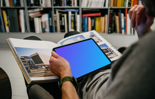 iPad Air mockup in a user’s hand in a library